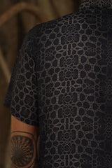Image of man wearing fractal of ash button up digital print shirt