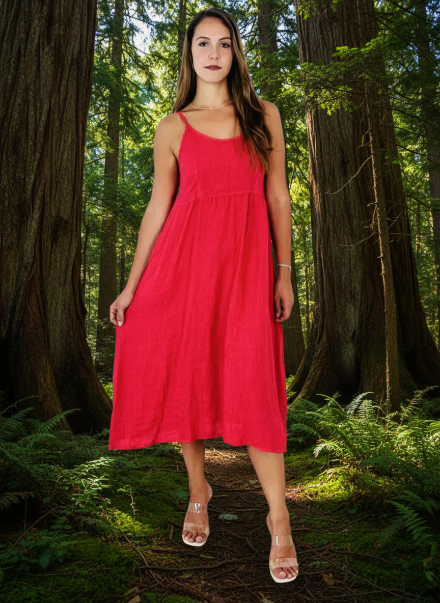 lady in coral colour dress in a forest of big trees