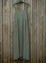 army dress hanging on a wooden wall on a hanger