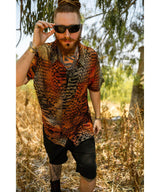 Man wearing a patterned shirt and sunglasses in a natural setting