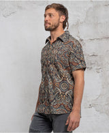man in a psycadelic owl pattern button-up cotton shirt