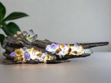 a wooden lamp with natural crystal set wwith light behind them