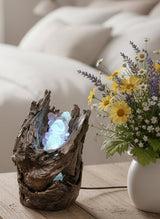 Decorative piece with a glowing crystal inside a wooden base on a cardboard box.