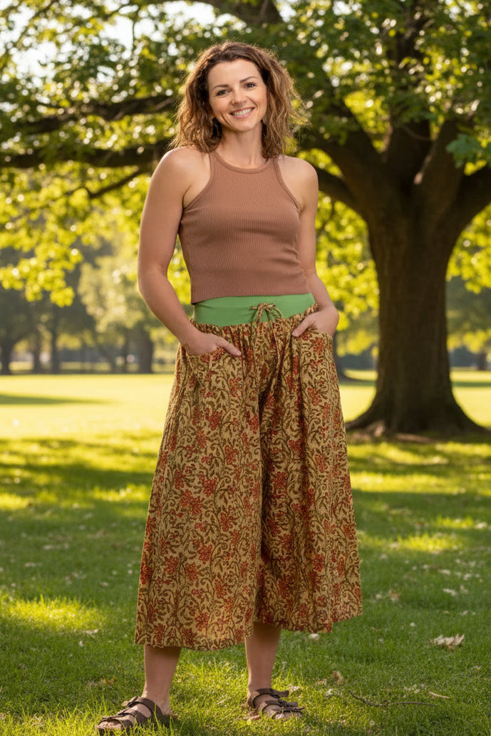 women wearing tan tank and wide leg 3/4 cotton pants in a park 
