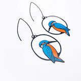 Bird-shaped earrings with blue and orange design on a white background