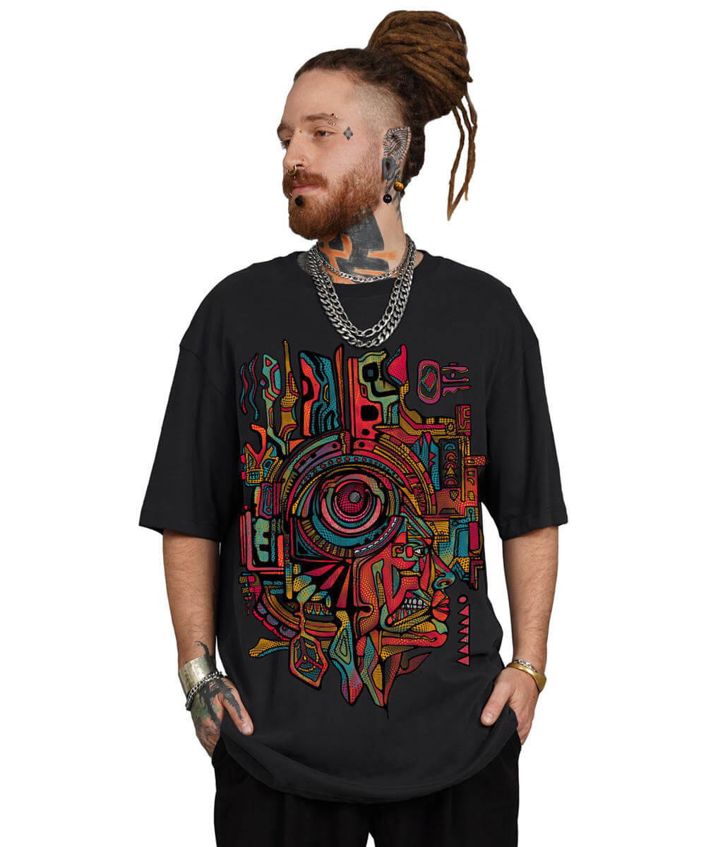 Man wearing a black t-shirt with a colorful abstract design on a white background