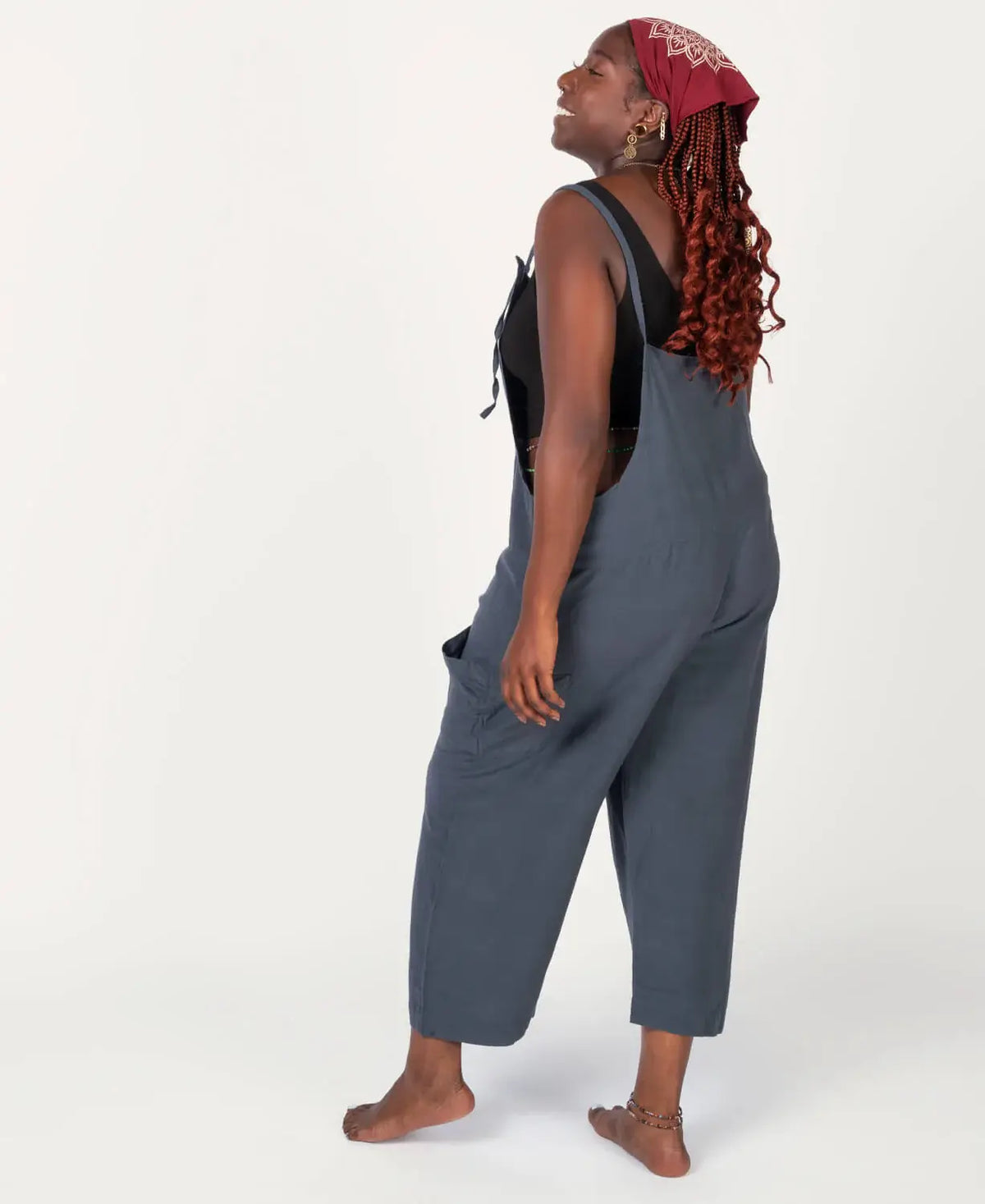 Person wearing a gray overalls on a white background