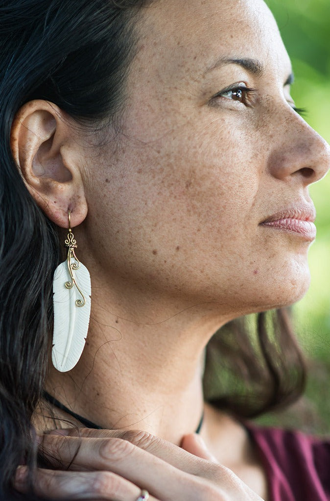 Hand carved bone feather earrings with brass swirl and hook