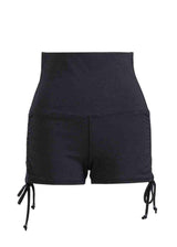 Black shorts with drawstrings on a white background