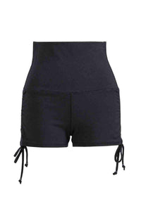 Black shorts with drawstrings on a white background