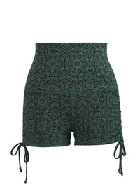 Green patterned shorts with drawstring on a white background