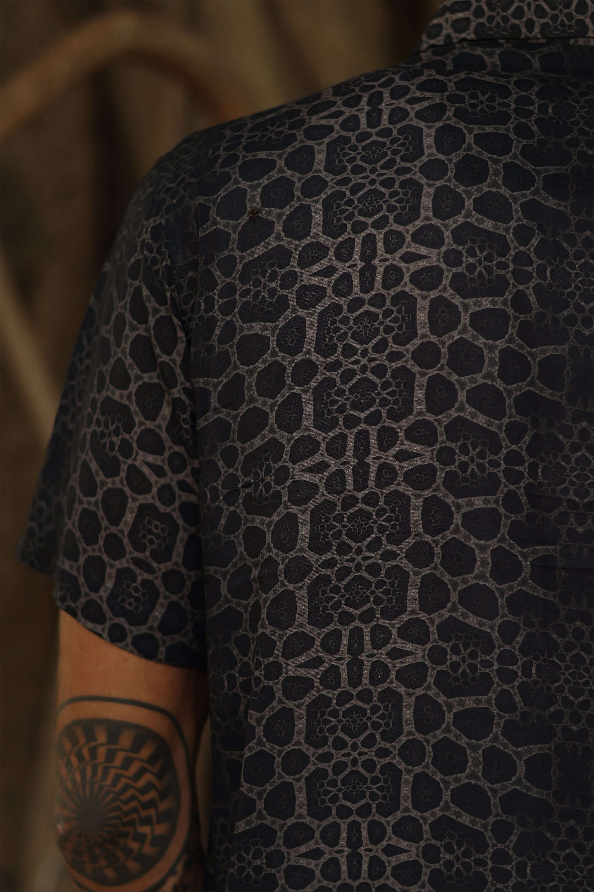 Image of man wearing fractal of ash button up digital print shirt