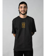 Person wearing a black t-shirt with a logo on a gray background