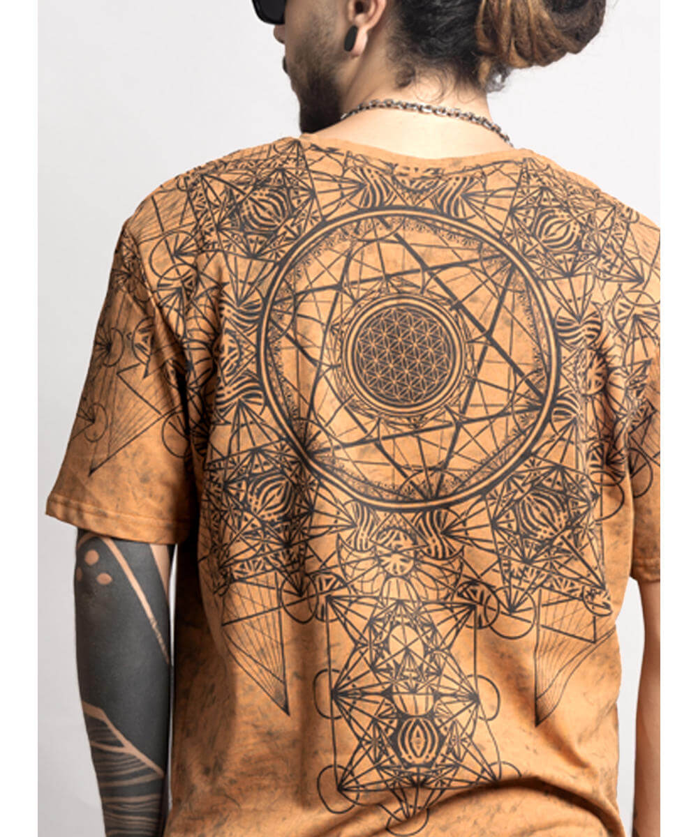Person wearing a brown t-shirt with geometric designs on the back
