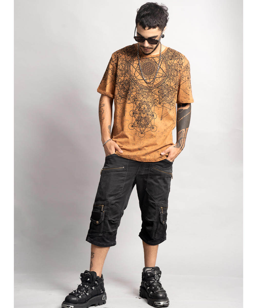Man wearing a patterned brown t-shirt and black cargo shorts on a white background