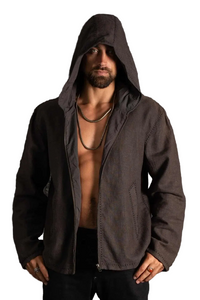A man wearing a dark brown hooded zip-up jacket, styled open to show the chest, standing against a dark textured background.