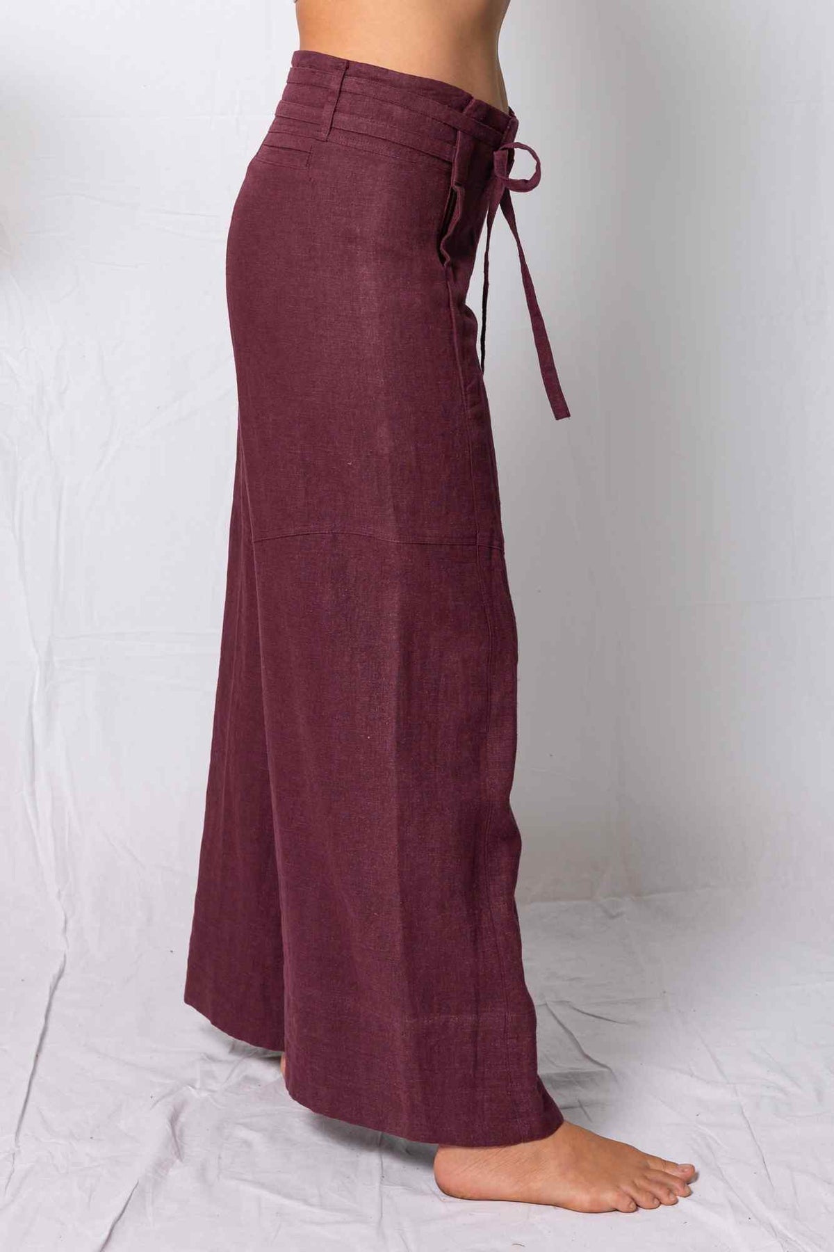Maroon wide-leg pants with a tie waist on a white background