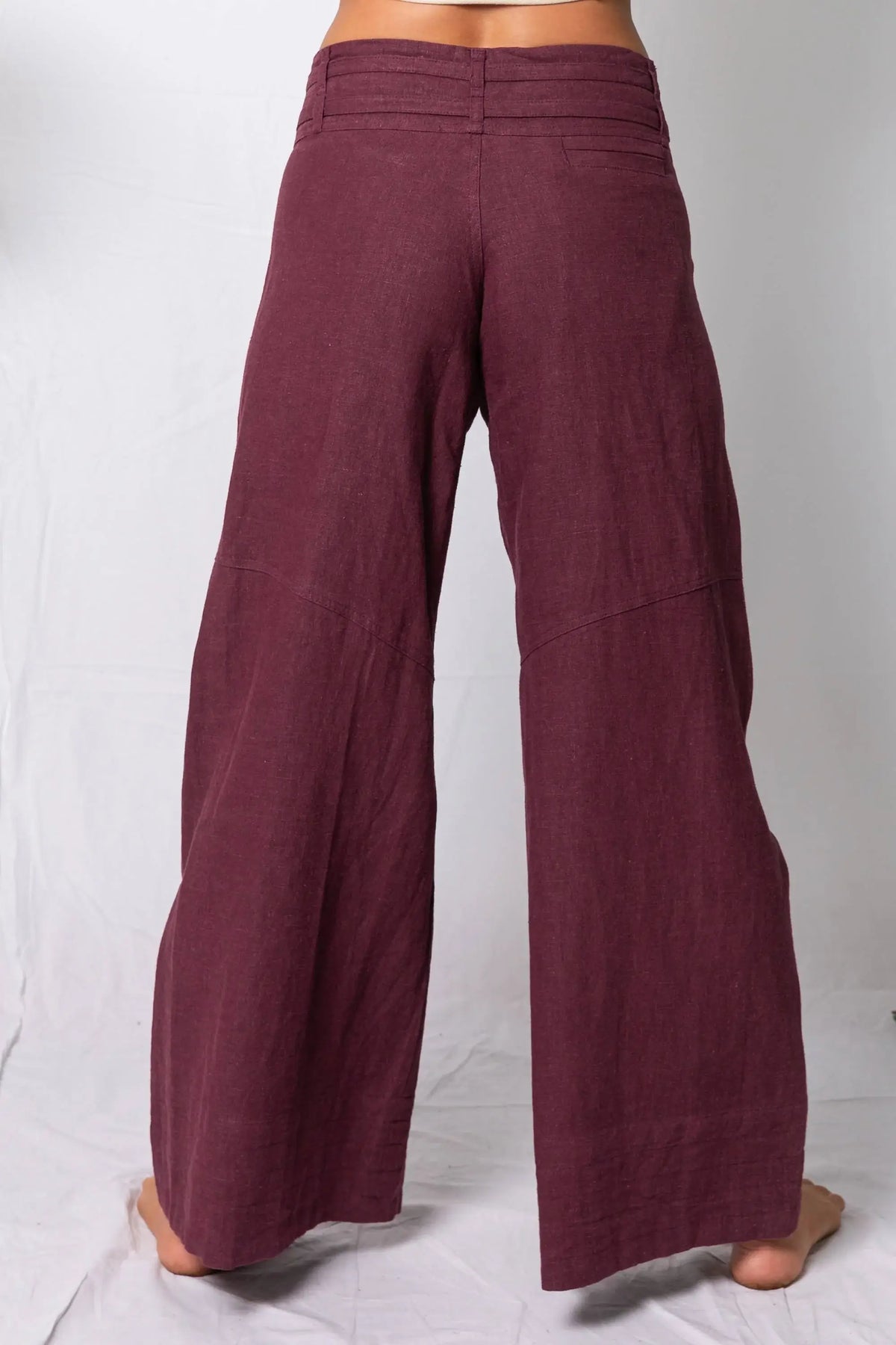 Maroon wide-leg pants on a white background