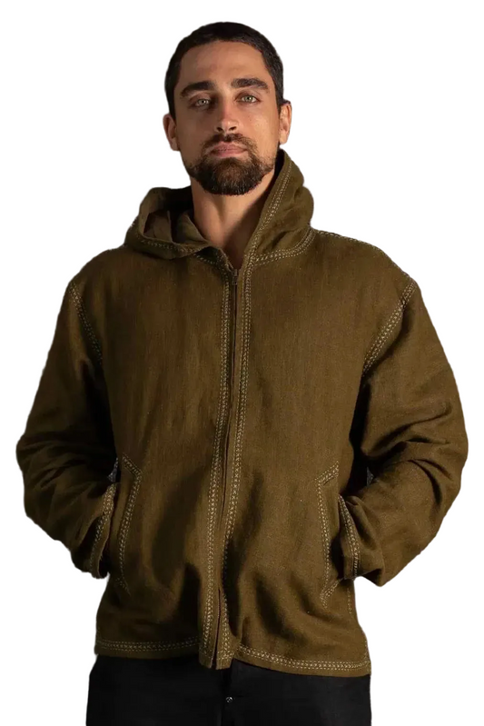 Man wearing a brown jacket against a dark textured background