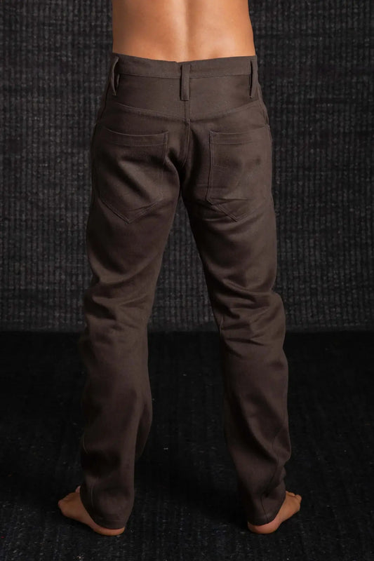 Brown pants worn by a person against a dark textured background