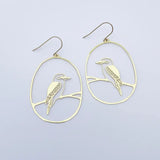 Gold bird-shaped earrings on a light gray background