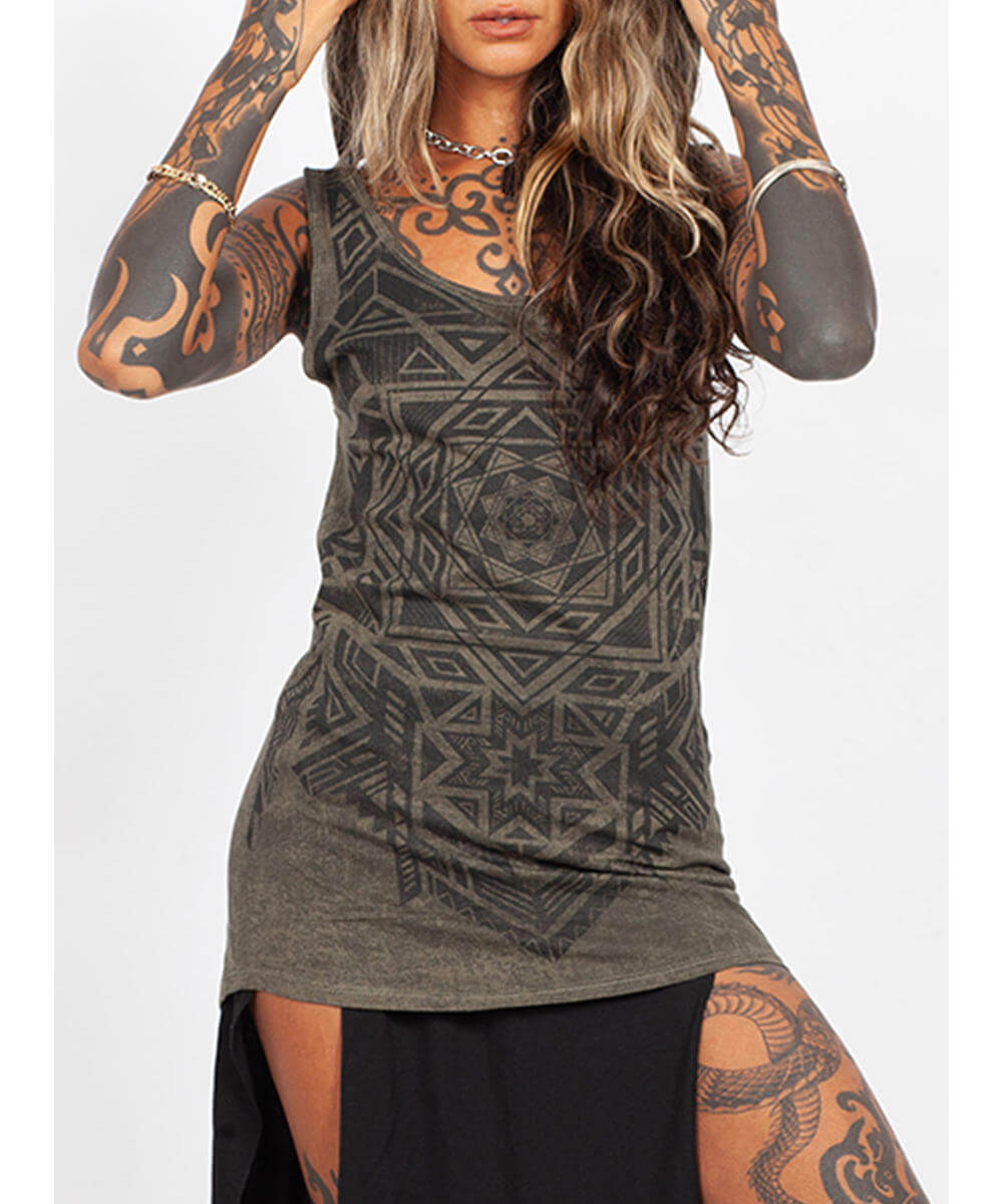 Woman wearing a dark green tank top with geometric patterns on a white background