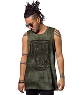 Man wearing a green sleeveless shirt with a tribal design on a white background