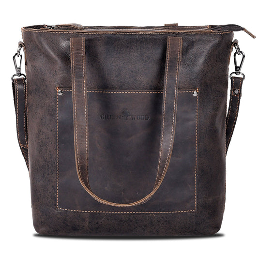 A dark brown distressed leather tote bag with double top handles, a front slip pocket with 'SWEETWOOD' debossed on it, and a detachable shoulder strap, shown against a plain white background.