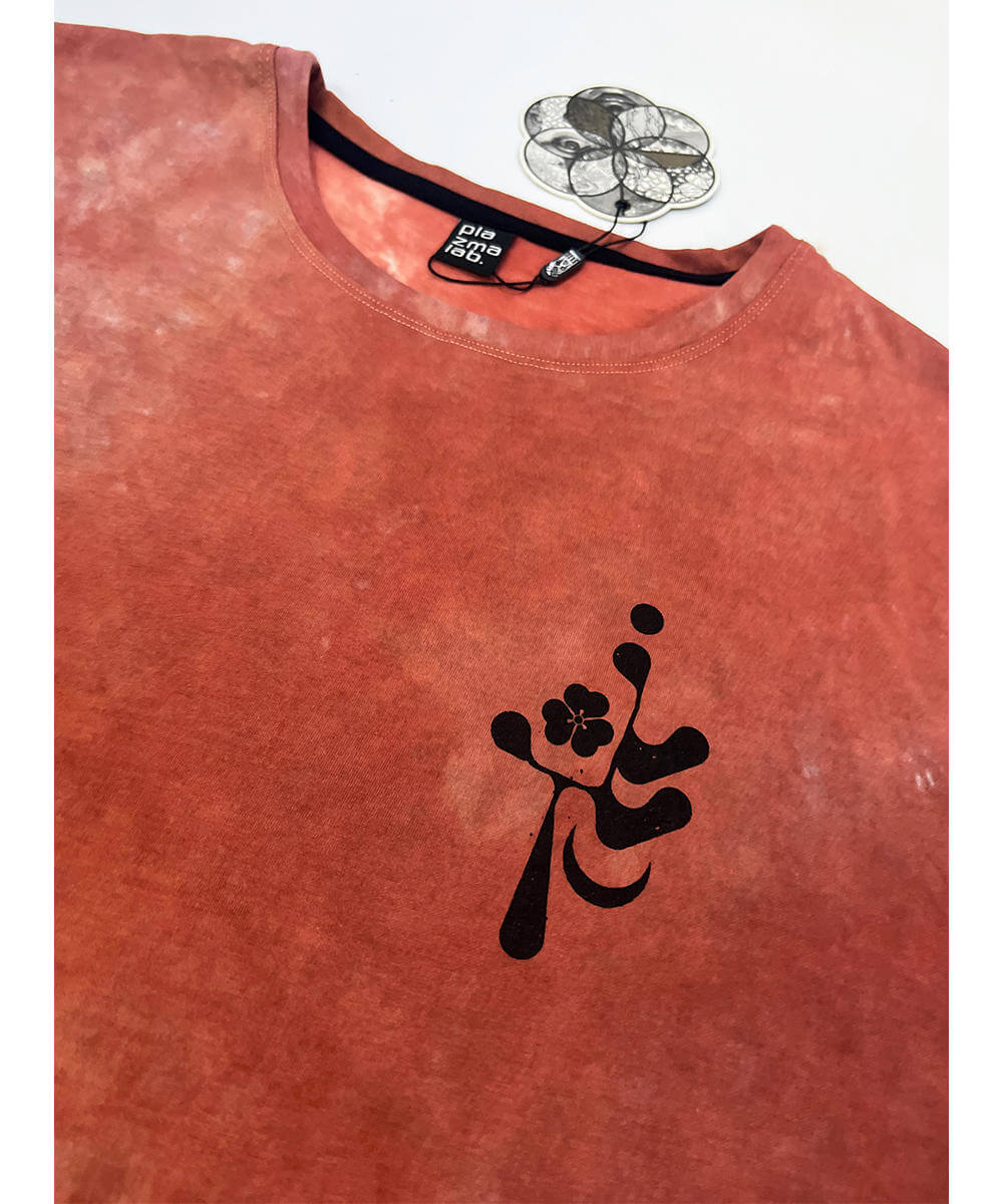 Red t-shirt with a black floral design on a white background