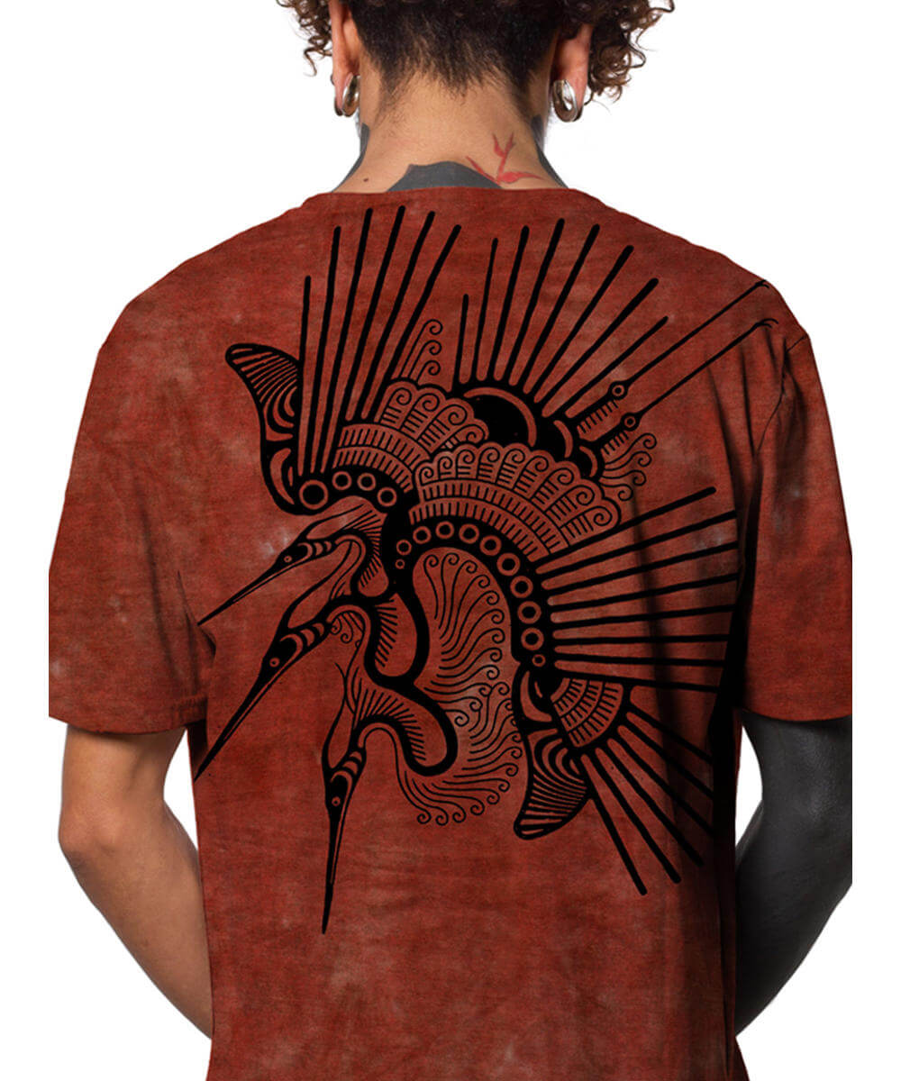 Person wearing a red t-shirt with a black tribal design on the back