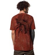 Man wearing a brown t-shirt with a black graphic design on the back, standing against a white background.