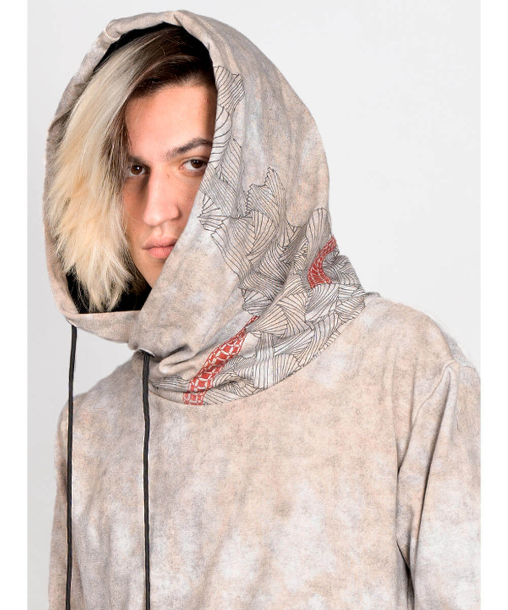 Person wearing a patterned hoodie with a neutral background