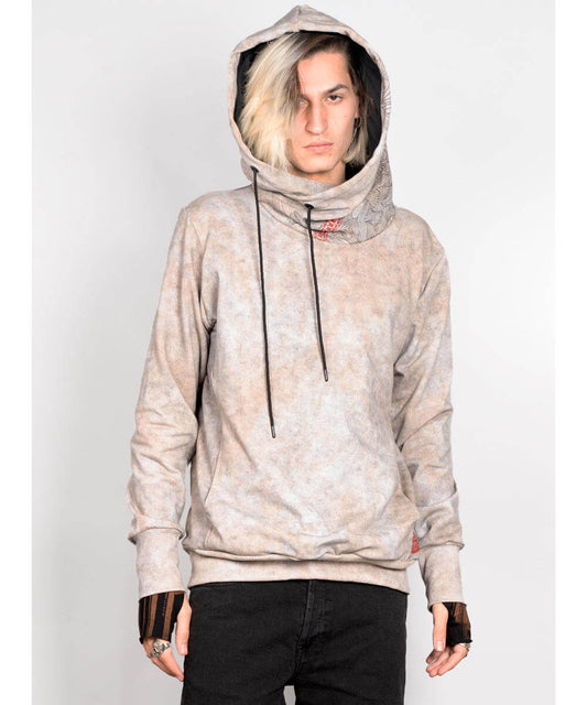 Person wearing a beige hoodie with a subtle pattern on a white background