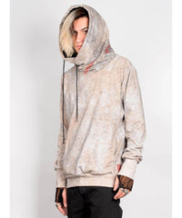 Person wearing a beige tie-dye hoodie with a white background