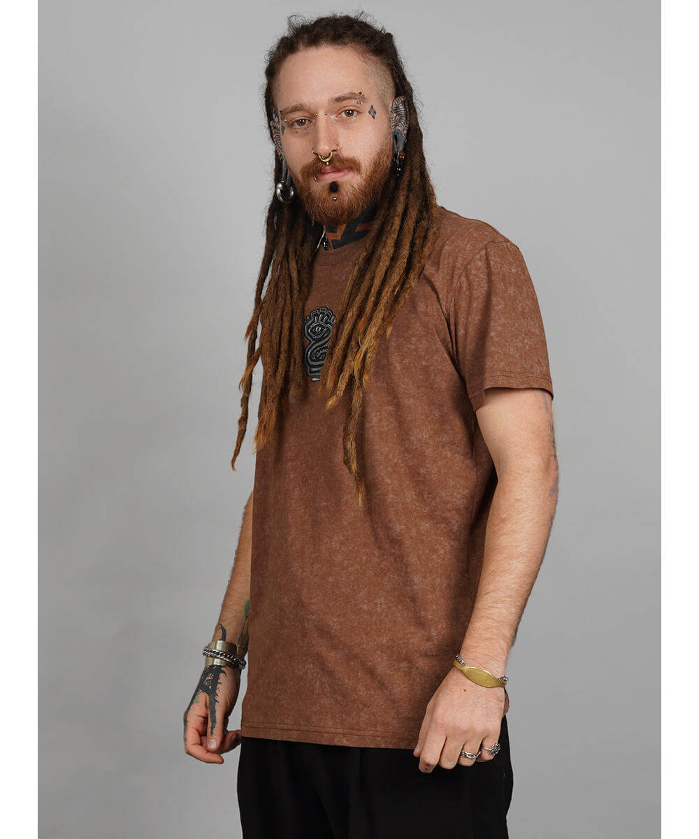 Man wearing a brown t-shirt with a logo on a gray background