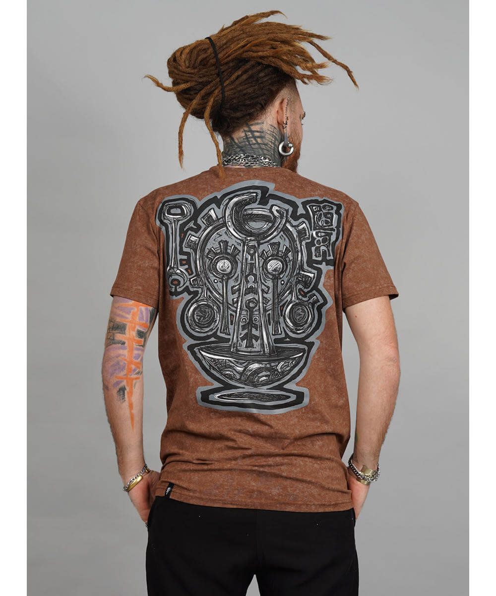 Person wearing a brown t-shirt with a detailed design on the back against a gray background