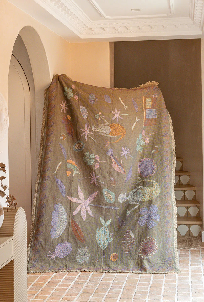Recycled cotton Abundance throw blanket in peach with decorative nature-inspired artwork for beds and sofas