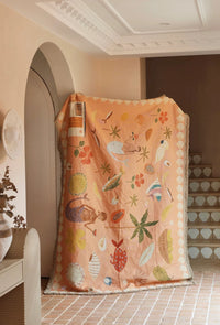 Abundance Art Throw Rug in earthy tones with colourful woven botanical and nature-inspired artwork