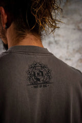 Person wearing a dark gray shirt with a geometric design and 'Art of Zig' text on the back.
