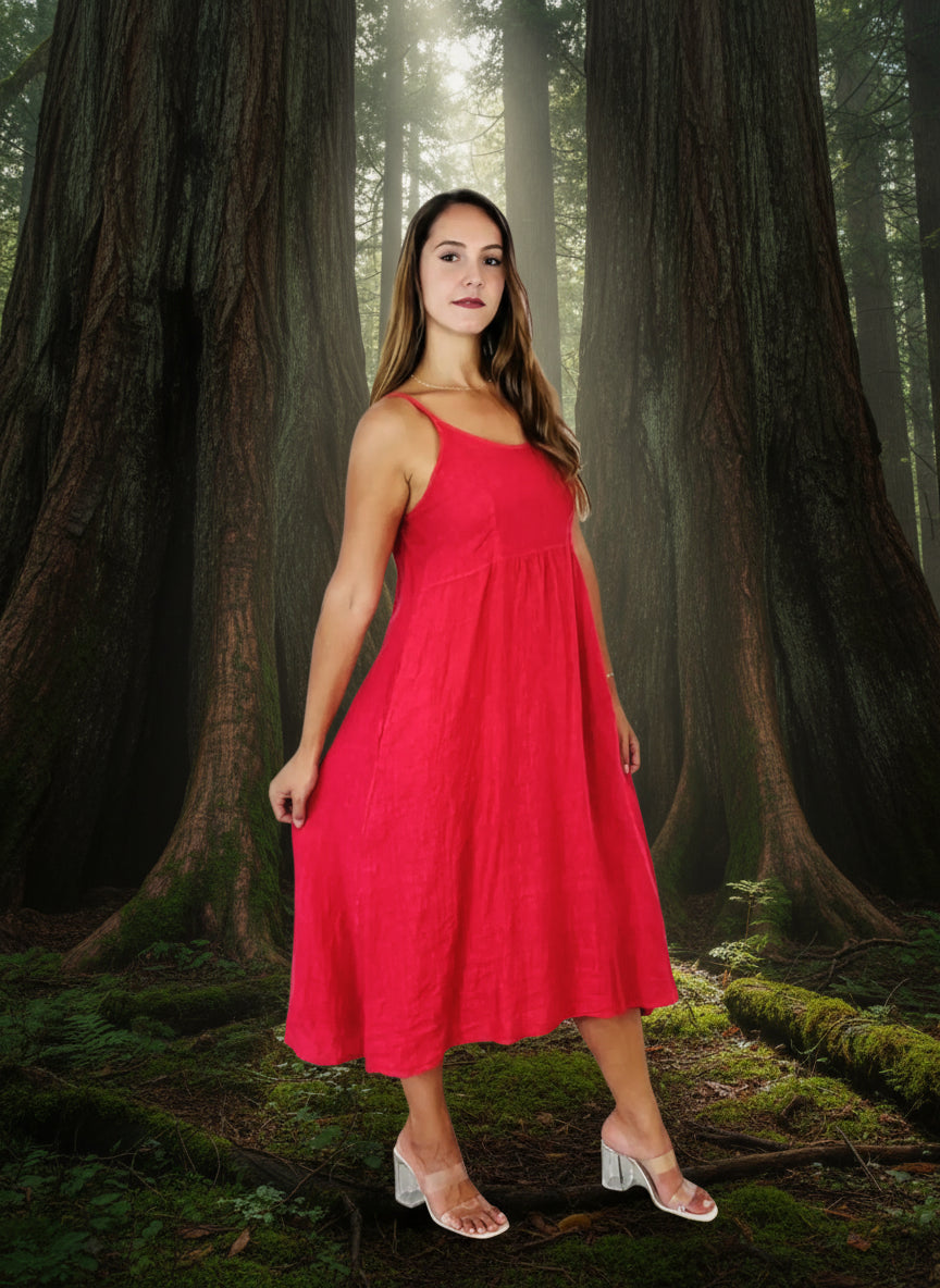 lady in coral colour dress in a forest of big trees