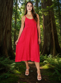 lady in coral colour dress in a forest of big trees