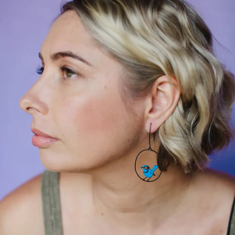 lady wearing blue wren earrings