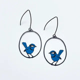 lady wearing blue wren earrings