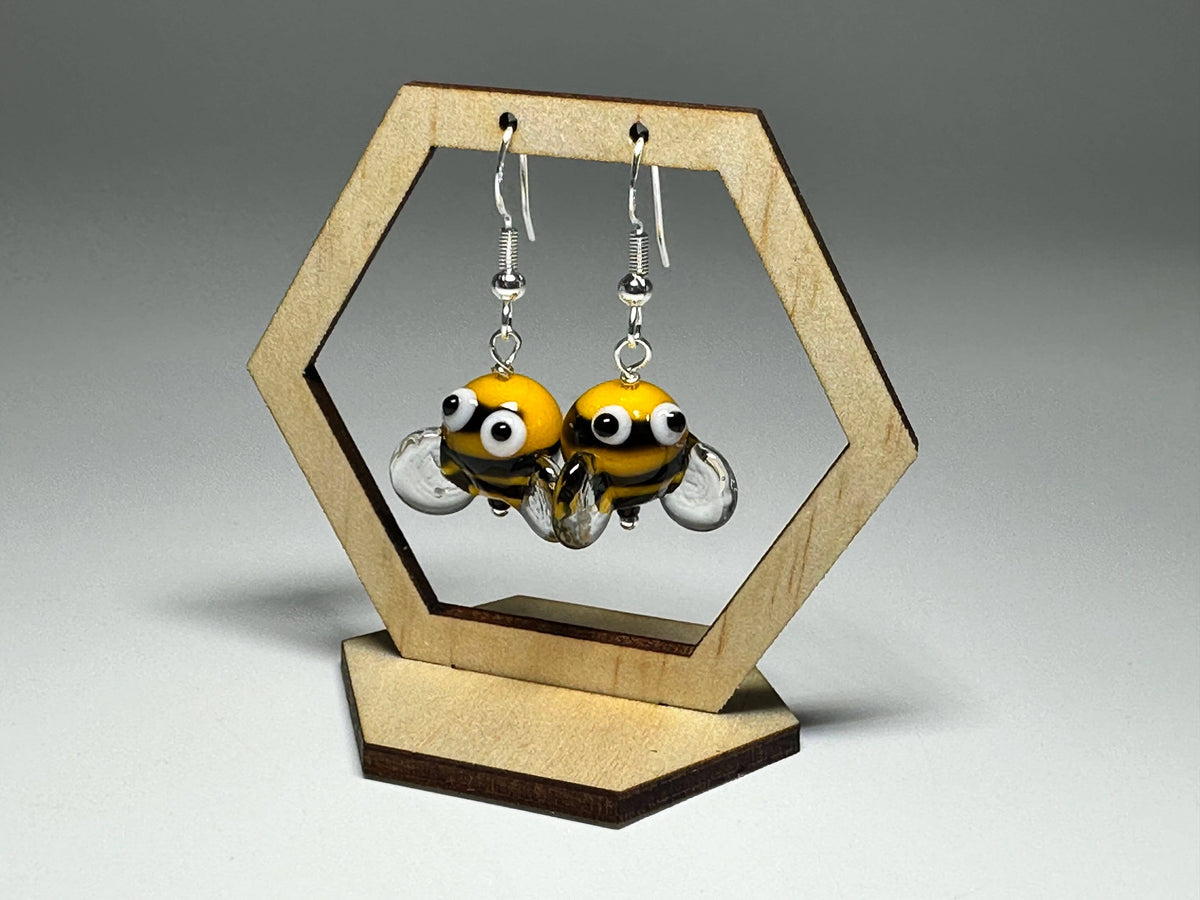 Close-up of Bumble Bee Glass Drop Earrings with playful googly eye details