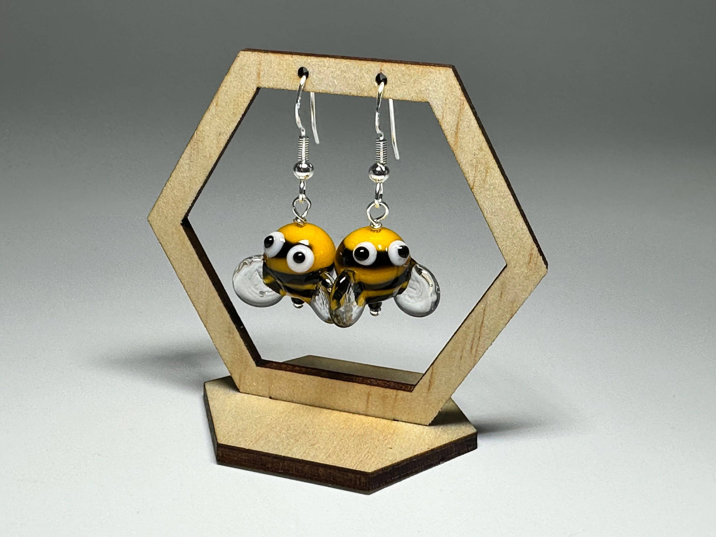 Close-up of Bumble Bee Glass Drop Earrings with playful googly eye details