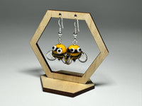 Close-up of Bumble Bee Glass Drop Earrings with playful googly eye details