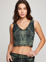 Woman wearing a green fern dyed
 tank top against a plain background