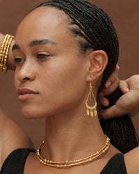 Dailia Earrings - 22k Gold Plated worn as long symbolic drop earrings with three trinkets