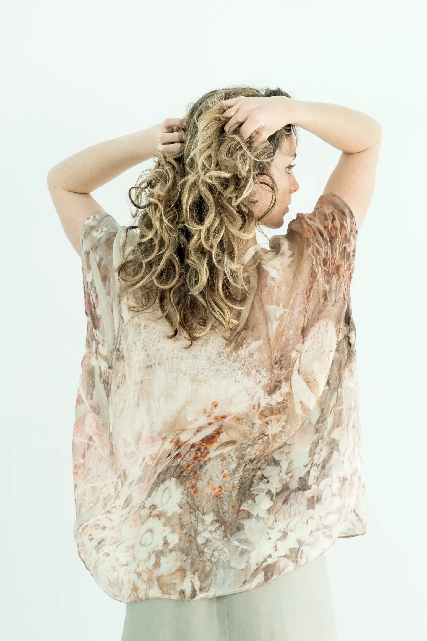 Woman wearing a floral blouse with a white background