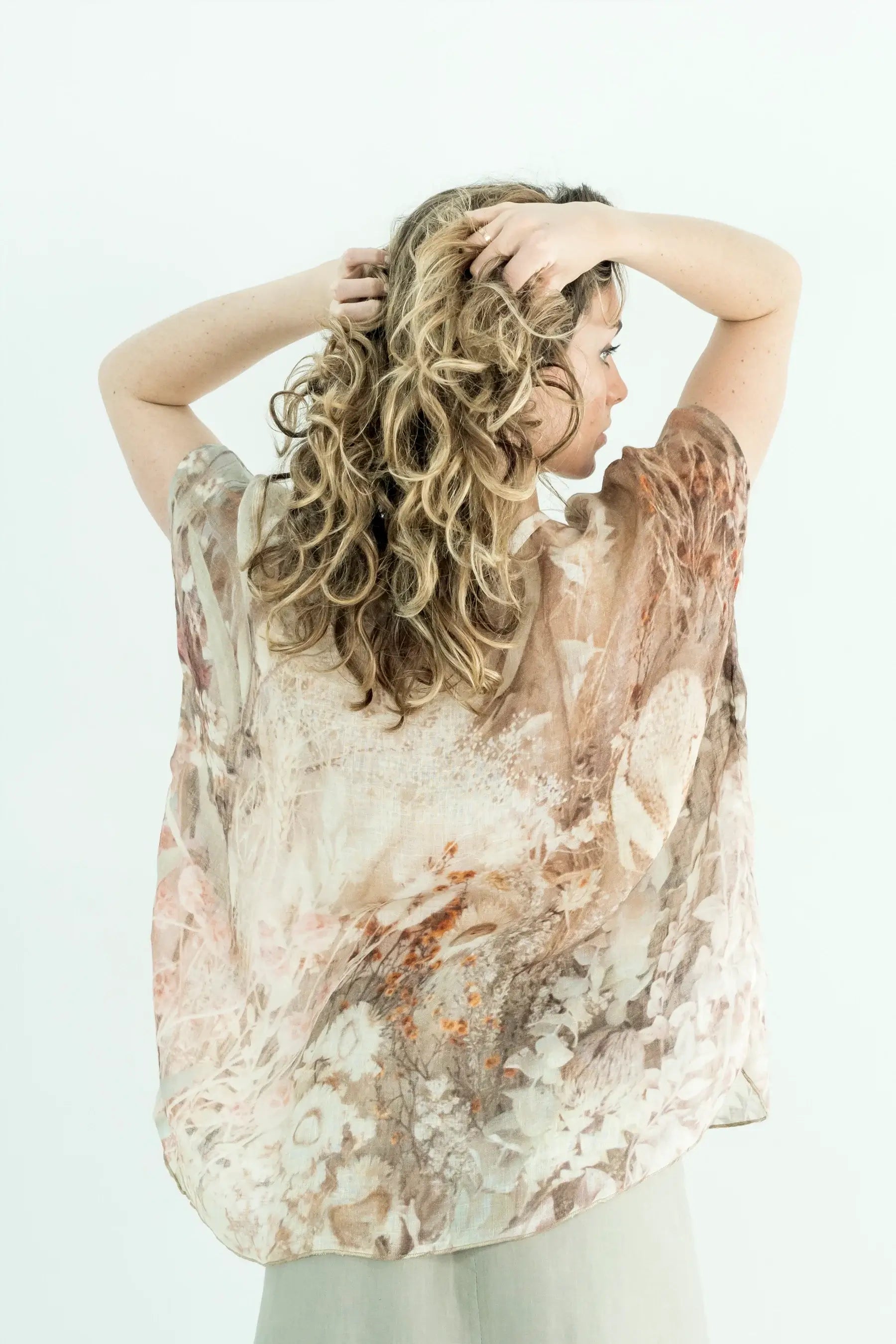 Woman wearing a floral blouse with a white background